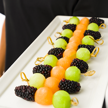 A fruit platter held by a student server